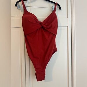 Good condition.  Burgundy/reddish one piece swimsuit.